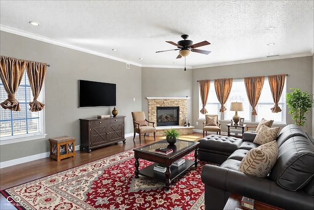 living room with plenty of natural light, wood finished floors, and crown molding