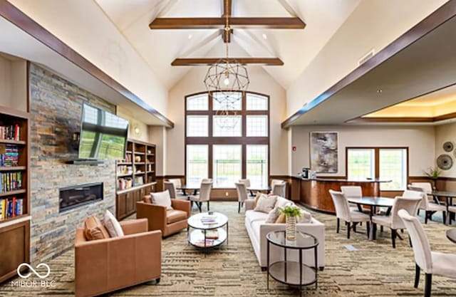 carpeted living area featuring high vaulted ceiling, beam ceiling, plenty of natural light, and a stone fireplace