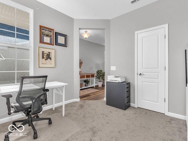 office space with carpet floors, visible vents, and baseboards