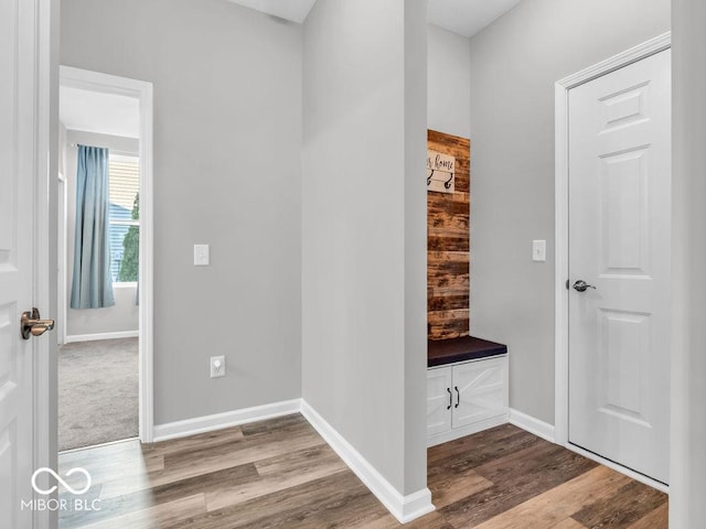 mudroom featuring light wood-style flooring and baseboards