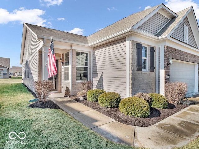 view of front of property featuring a garage, stone siding, a front lawn, and brick siding