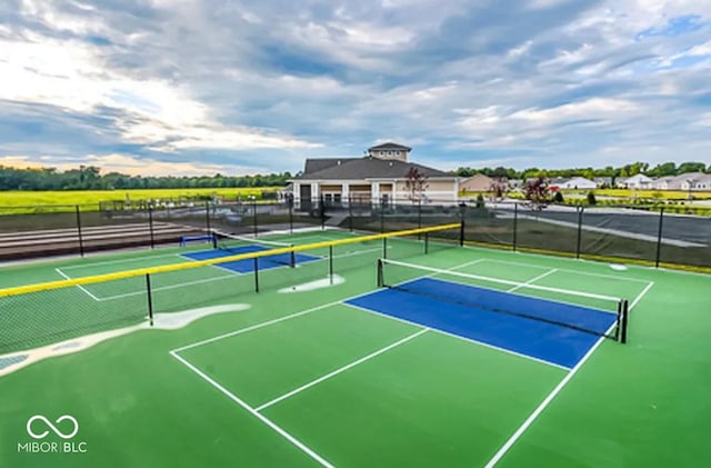 view of tennis court with fence