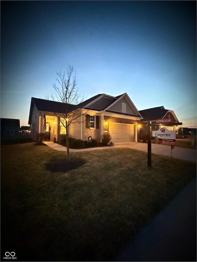 single story home with an attached garage, driveway, and a front yard