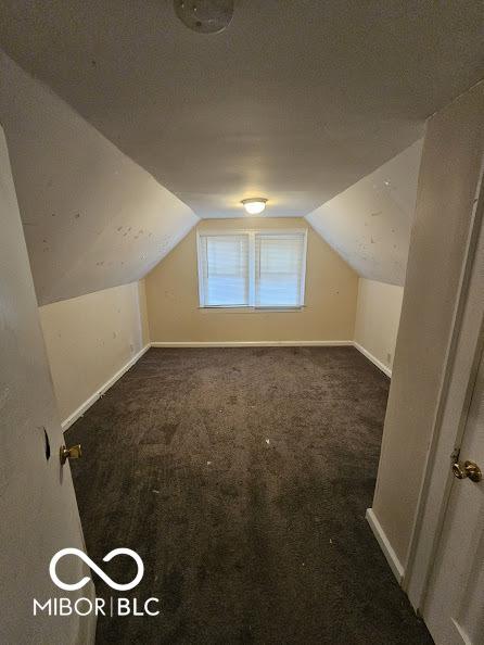 bonus room with vaulted ceiling, baseboards, and carpet