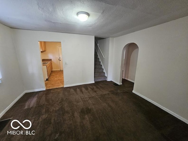 spare room featuring baseboards, carpet, and stairs