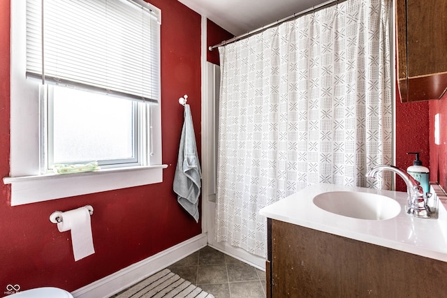 bathroom featuring a shower with curtain, vanity, baseboards, and tile patterned floors