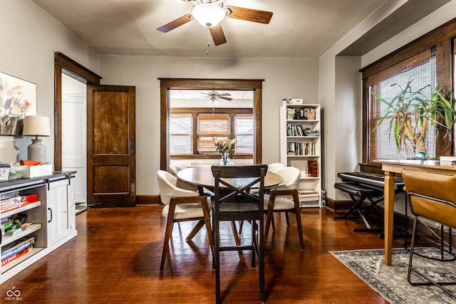 dining room with baseboards, dark wood-type flooring, and a wealth of natural light