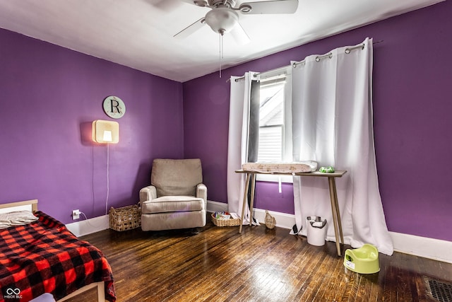 bedroom featuring a ceiling fan, wood-type flooring, visible vents, and baseboards