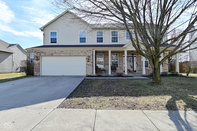 view of front of home with covered porch, concrete driveway, brick siding, and a garage