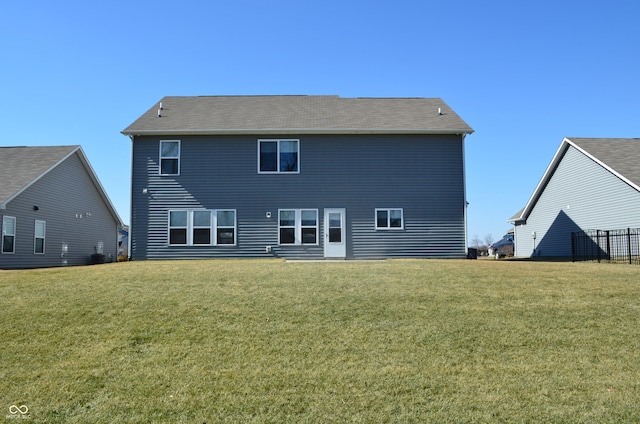 rear view of house with a yard