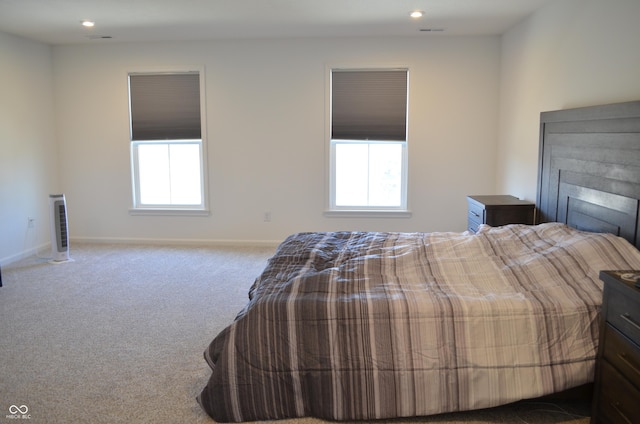 carpeted bedroom with multiple windows, baseboards, a fireplace, and recessed lighting