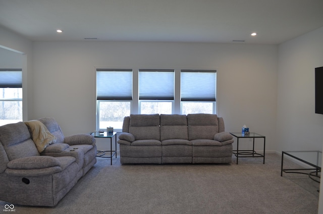 living room with recessed lighting and light colored carpet