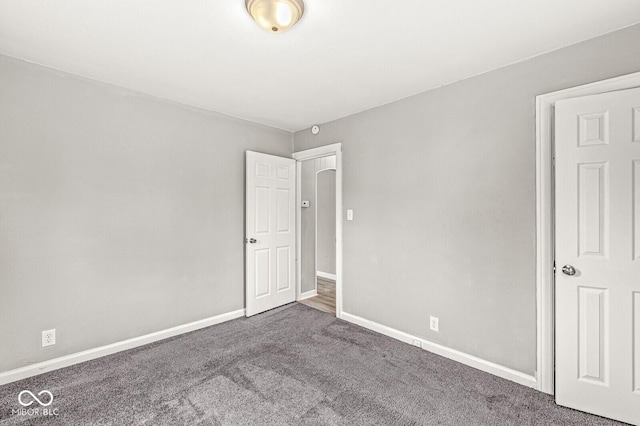 unfurnished bedroom featuring baseboards and carpet flooring