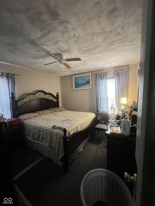 bedroom featuring ceiling fan and a textured ceiling