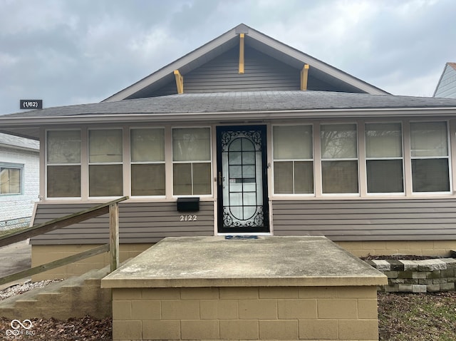 exterior space featuring a shingled roof