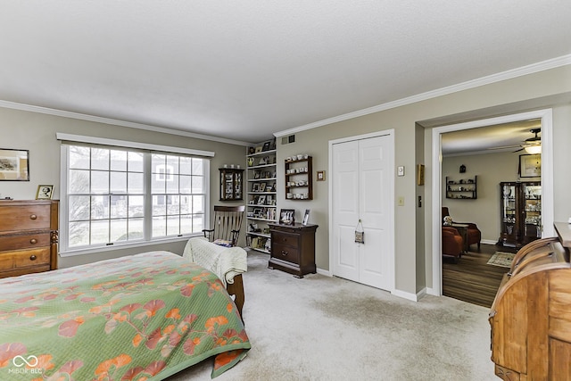 bedroom featuring baseboards, ornamental molding, visible vents, and light colored carpet