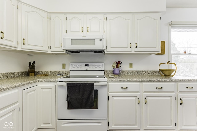 kitchen featuring white appliances, white cabinetry, and light countertops