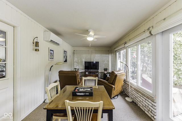 sunroom / solarium with a ceiling fan, a healthy amount of sunlight, and a wall mounted AC