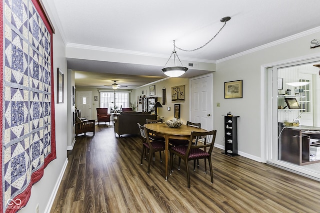 dining room featuring baseboards, visible vents, ornamental molding, and dark wood-type flooring