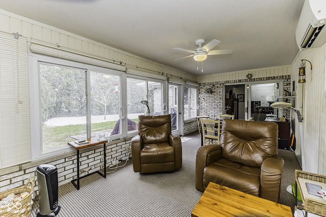 sunroom / solarium with a wall mounted AC and a ceiling fan