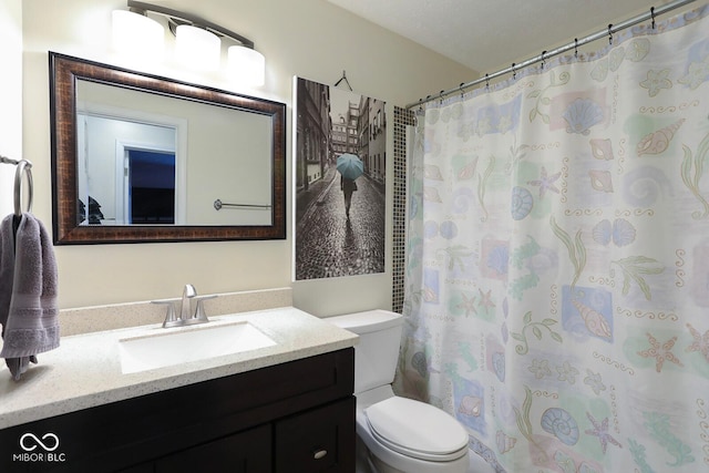 bathroom with a shower with shower curtain, vanity, and toilet