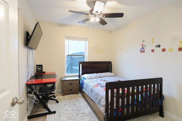 bedroom with a ceiling fan and baseboards