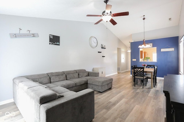 living room featuring ceiling fan, light wood-style flooring, and baseboards