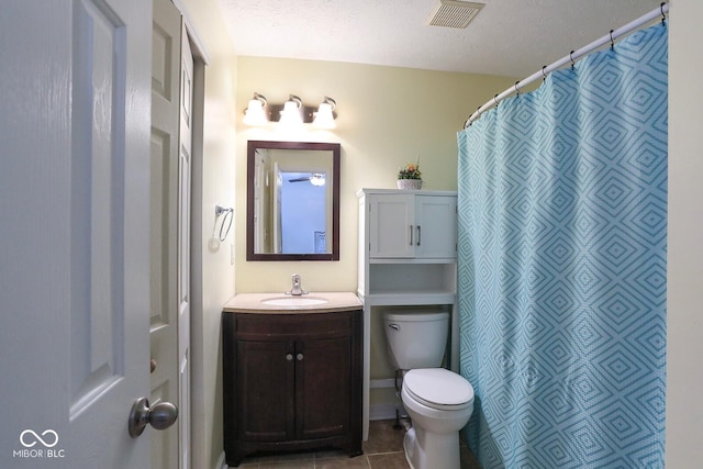 bathroom with visible vents, toilet, tile patterned floors, a textured ceiling, and vanity