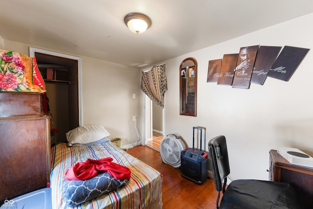 bedroom with dark wood-style floors and baseboards