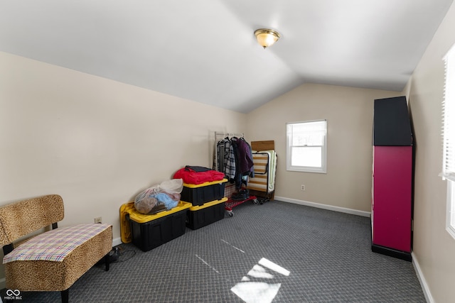 bonus room with lofted ceiling, dark carpet, and baseboards