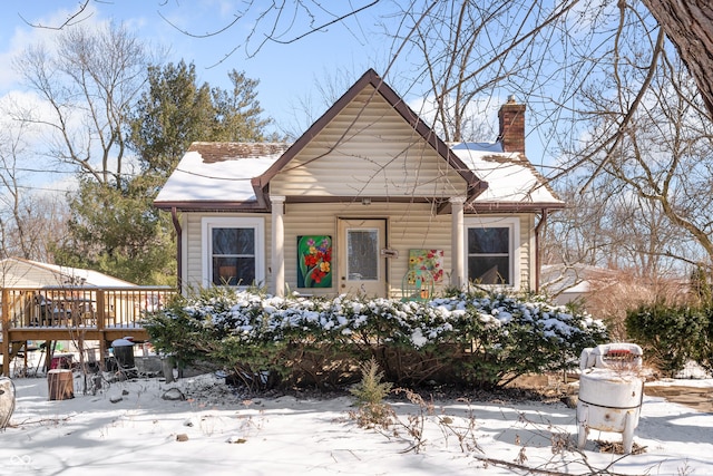 view of front of home with a chimney and a deck