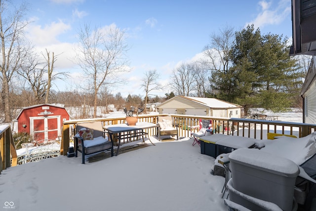 snow covered deck with an outdoor structure and a storage unit