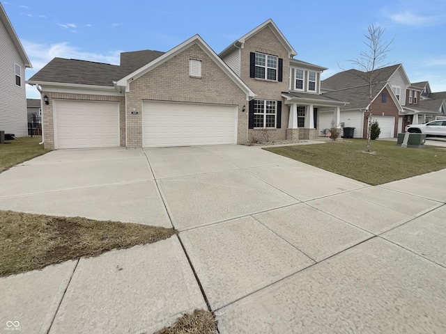 traditional home featuring an attached garage, driveway, a front yard, and brick siding