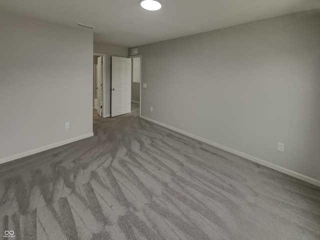 unfurnished room with visible vents and baseboards