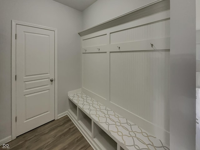 mudroom with dark wood-type flooring and baseboards