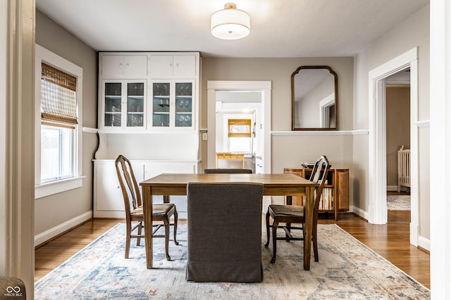 dining room featuring baseboards and wood finished floors