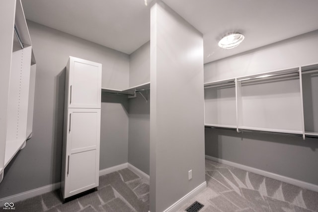 spacious closet with carpet flooring and visible vents