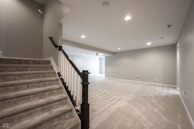 stairs with carpet floors, visible vents, baseboards, and recessed lighting