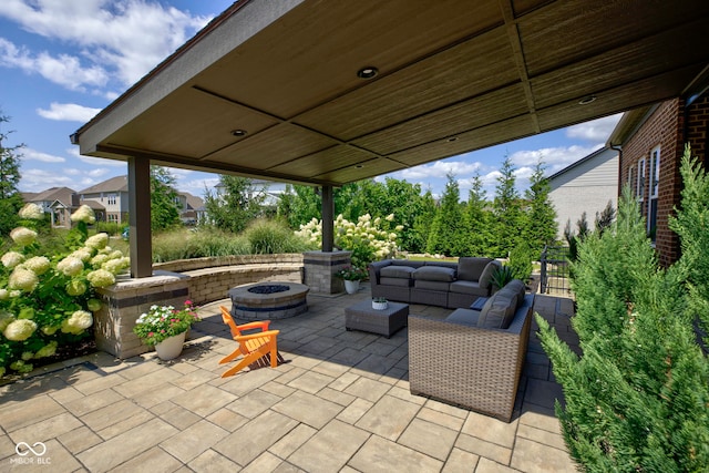 view of patio / terrace with an outdoor living space with a fire pit