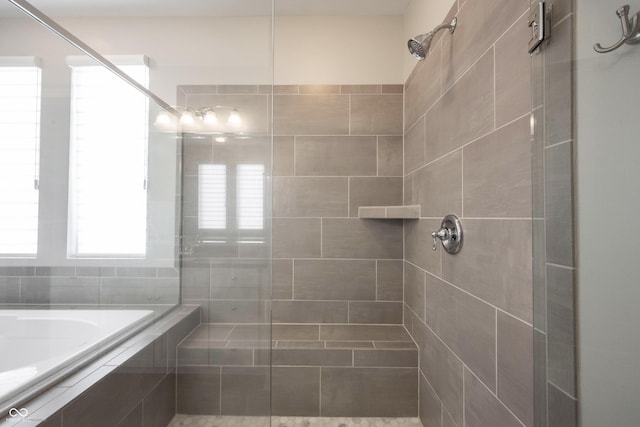 bathroom featuring tiled shower and a garden tub