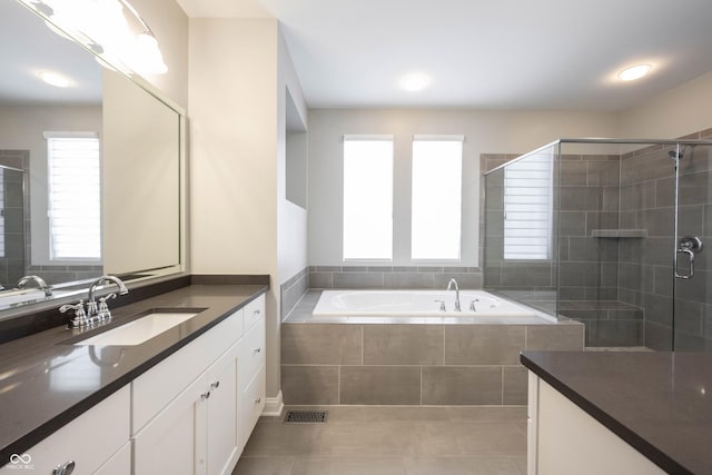 full bath with visible vents, a stall shower, vanity, a bath, and tile patterned floors