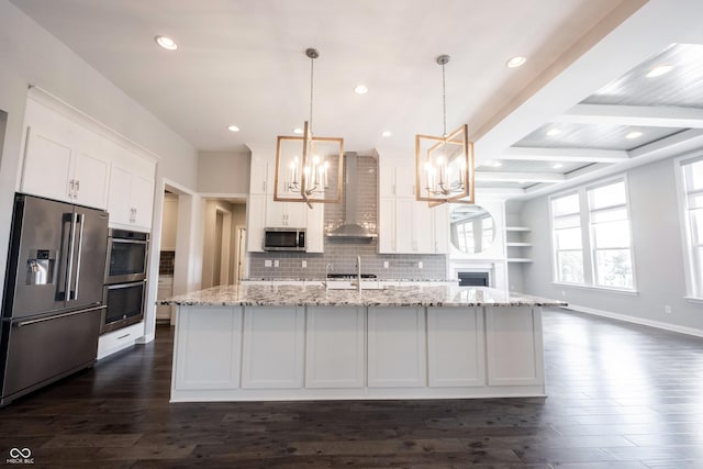 kitchen with appliances with stainless steel finishes, white cabinets, dark wood-type flooring, and wall chimney exhaust hood