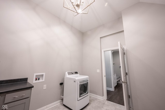 washroom with washer / dryer, light tile patterned floors, laundry area, baseboards, and an inviting chandelier