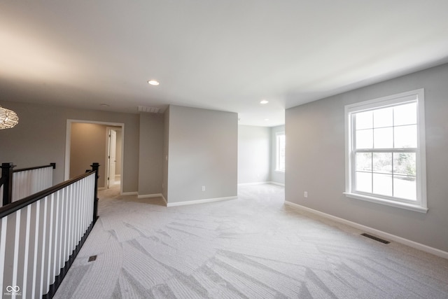 unfurnished room with baseboards, visible vents, and recessed lighting