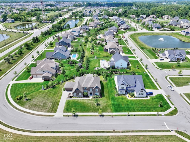 birds eye view of property with a water view and a residential view