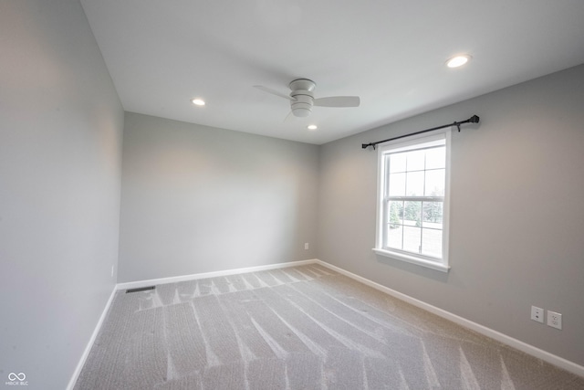 carpeted empty room featuring visible vents, baseboards, a ceiling fan, and recessed lighting