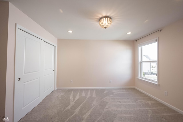 unfurnished bedroom with recessed lighting, carpet flooring, and baseboards