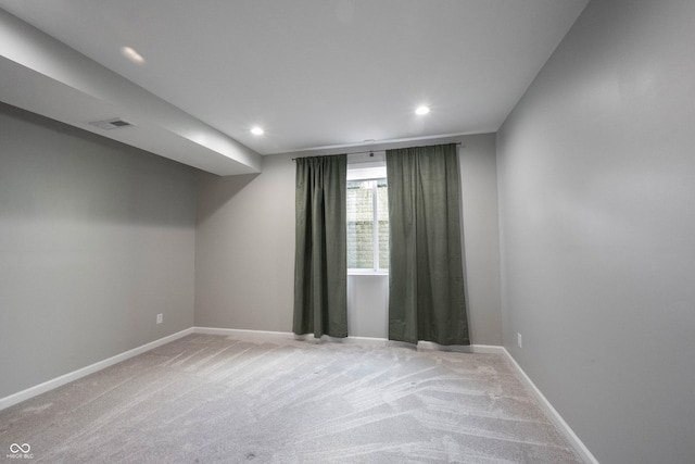 carpeted empty room with visible vents, baseboards, and recessed lighting