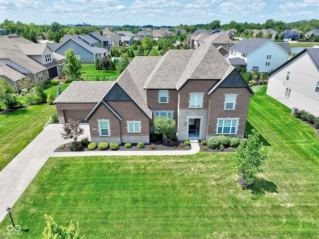 view of front of house with driveway, a garage, a residential view, a front lawn, and brick siding