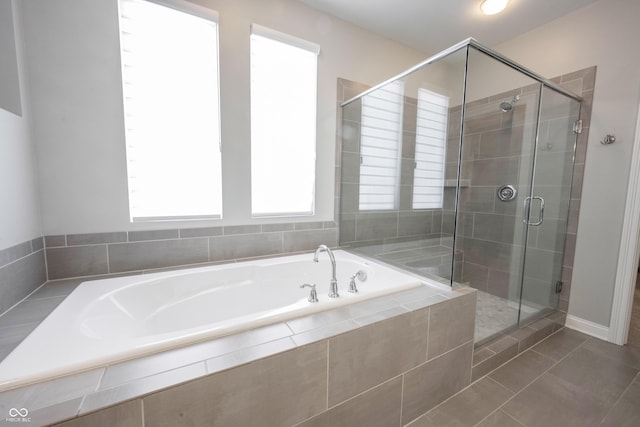 bathroom with tile patterned floors, a shower stall, and a bath